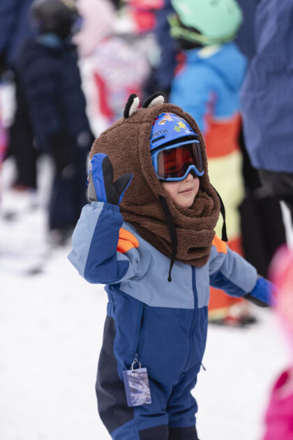 Child giving a high-five in ski gear